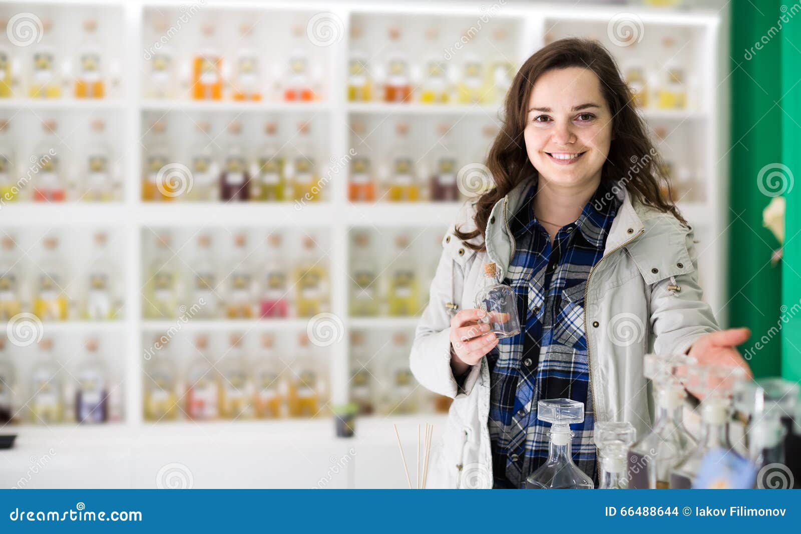 Portrait of brunette shopping in perfume store. Portrait of happy young brunette shopping in perfume store