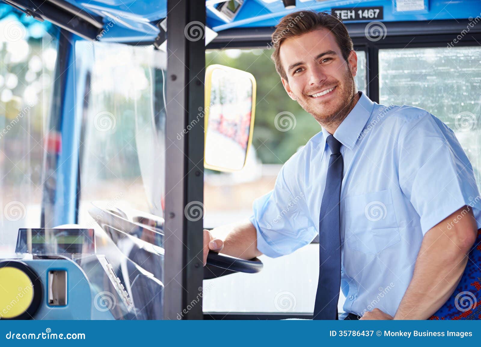 portrait of bus driver behind wheel