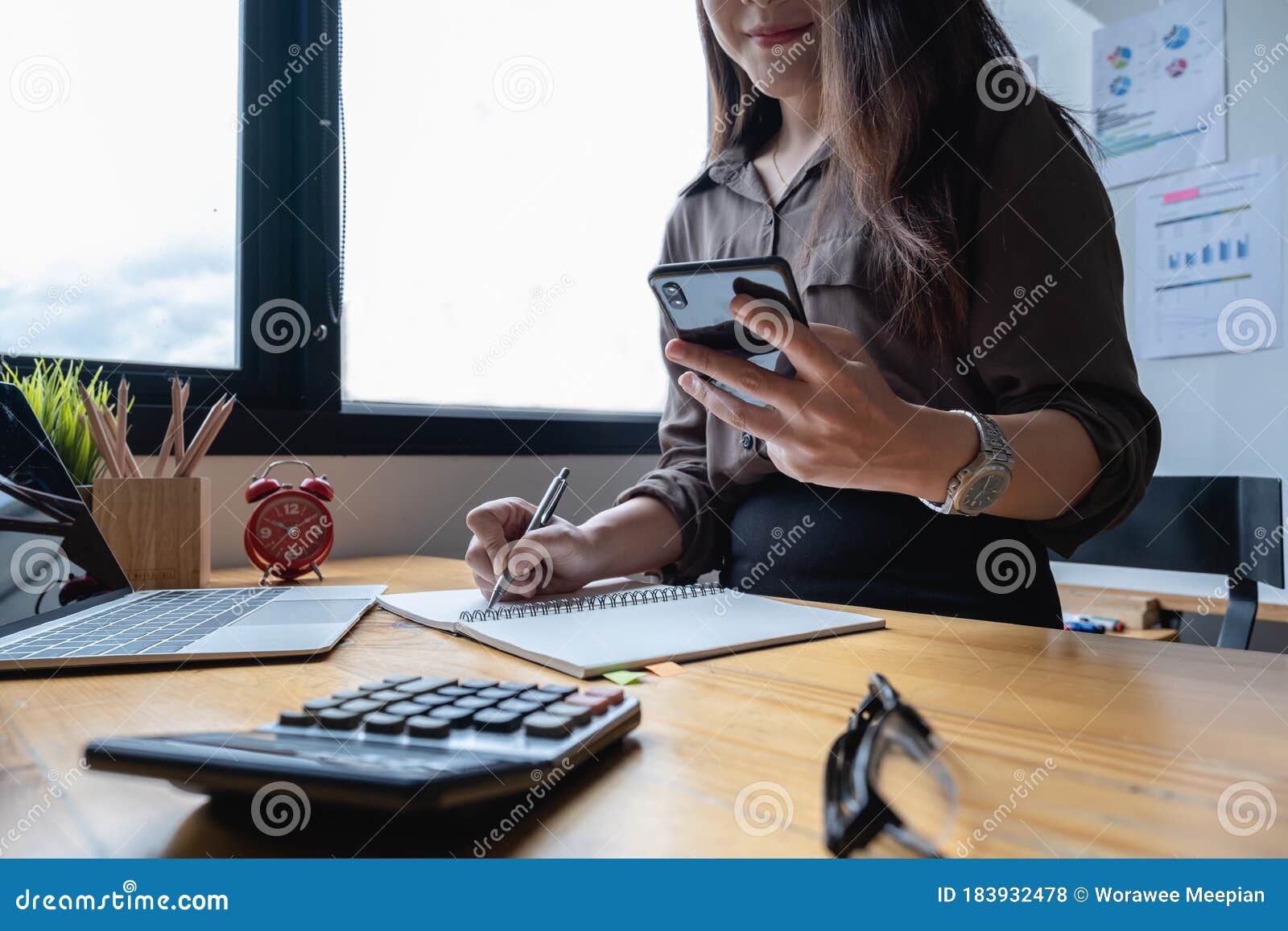 portrait of business woman and smiling using video call on smartphone with her parents. quarantine and work from home concept