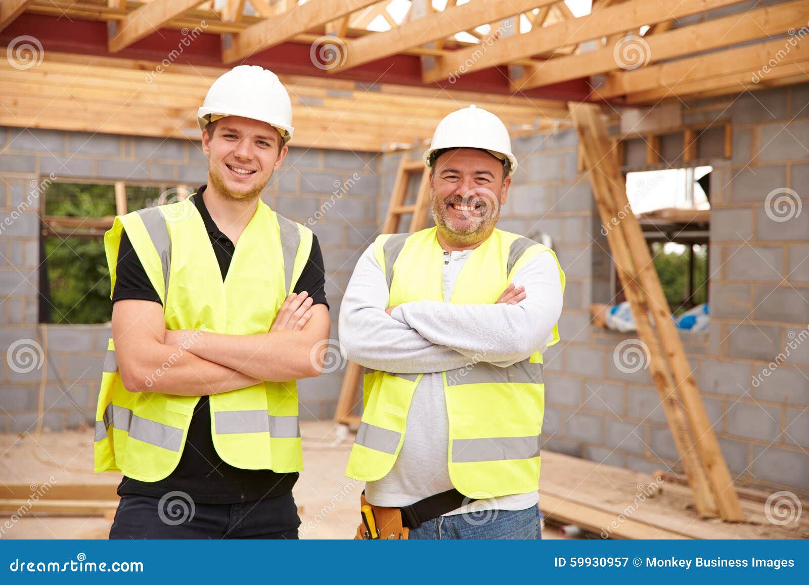 Portrait Of Carpenter With Apprentice Working On Site ...