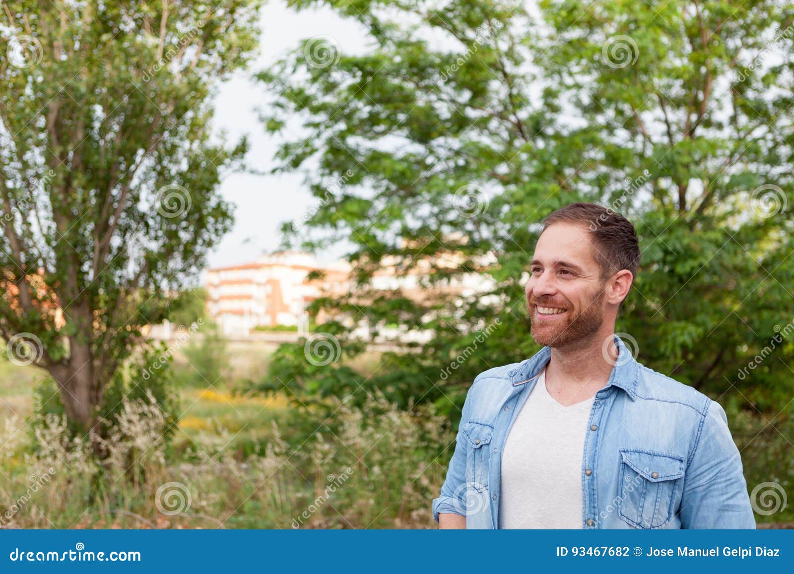 Portrait of a casual men in a park. Portrait of a casual man with denim shirt in a park