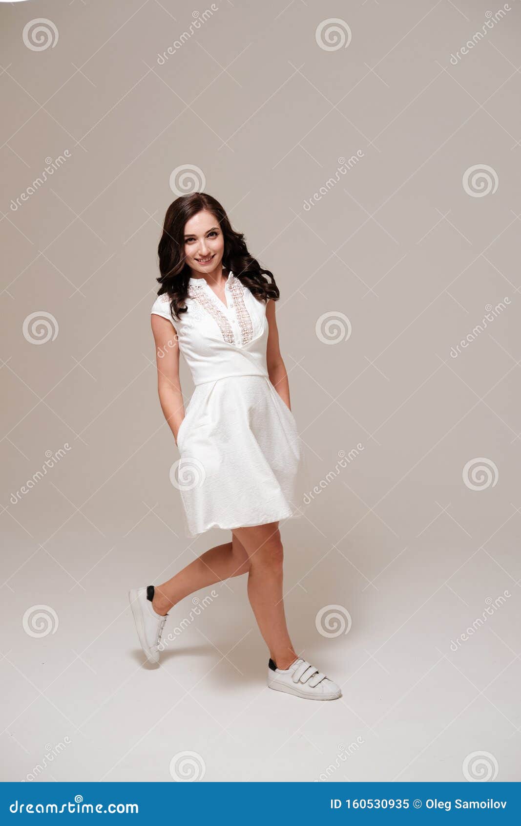 Portrait Casual Woman in White Dress and Sneakers Stock Image