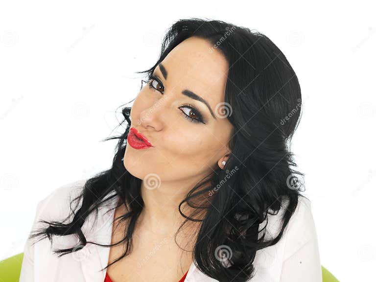 Portrait Of A Cheeky Young Hispanic Woman Pulling Silly Faces Stock 