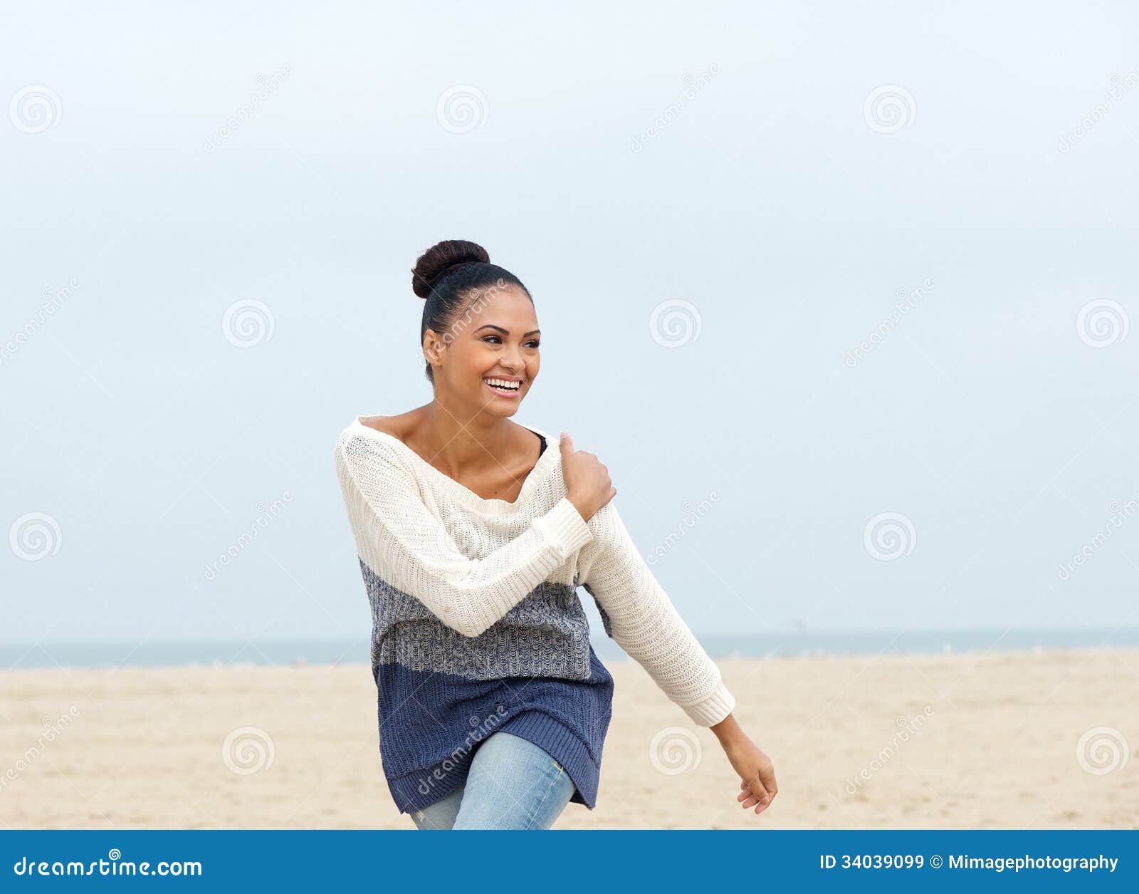 Portrait Of A Cheerful Carefree Young Woman Walking On The Beach ...