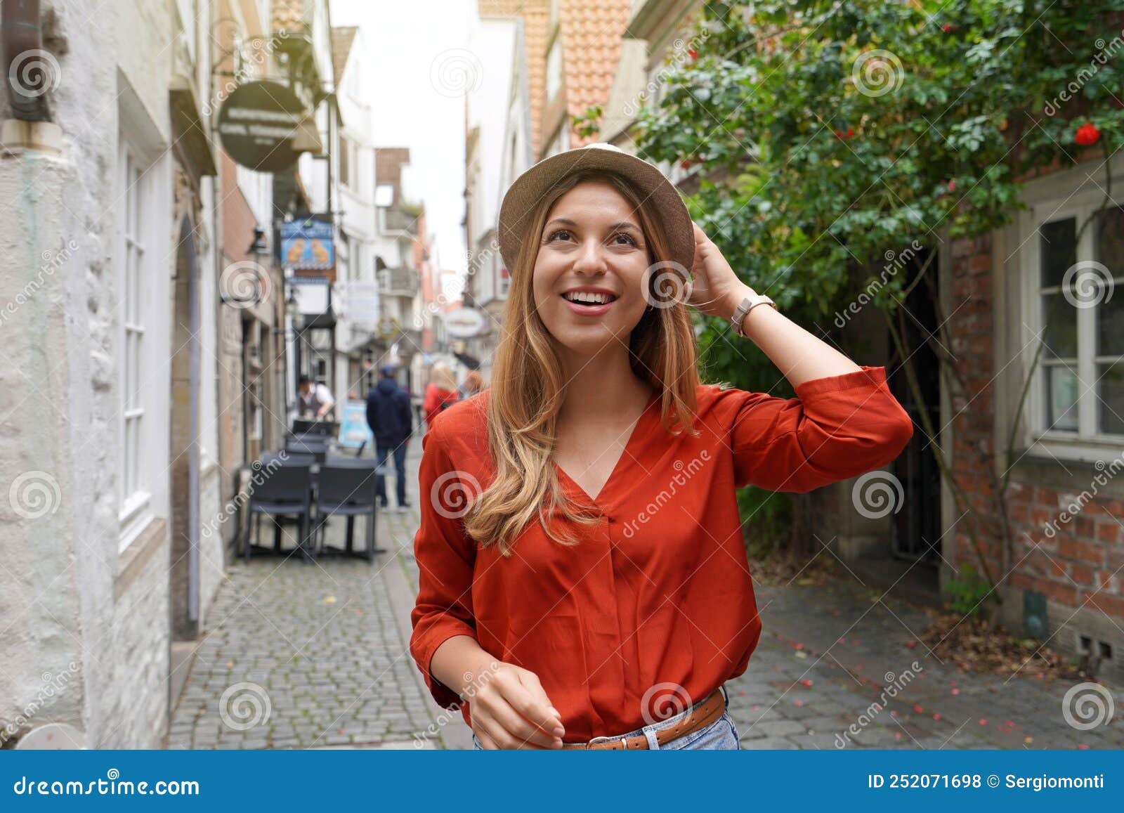 Portrait of Cheerful Traveler Woman Walking in Schnoor Neighborhood