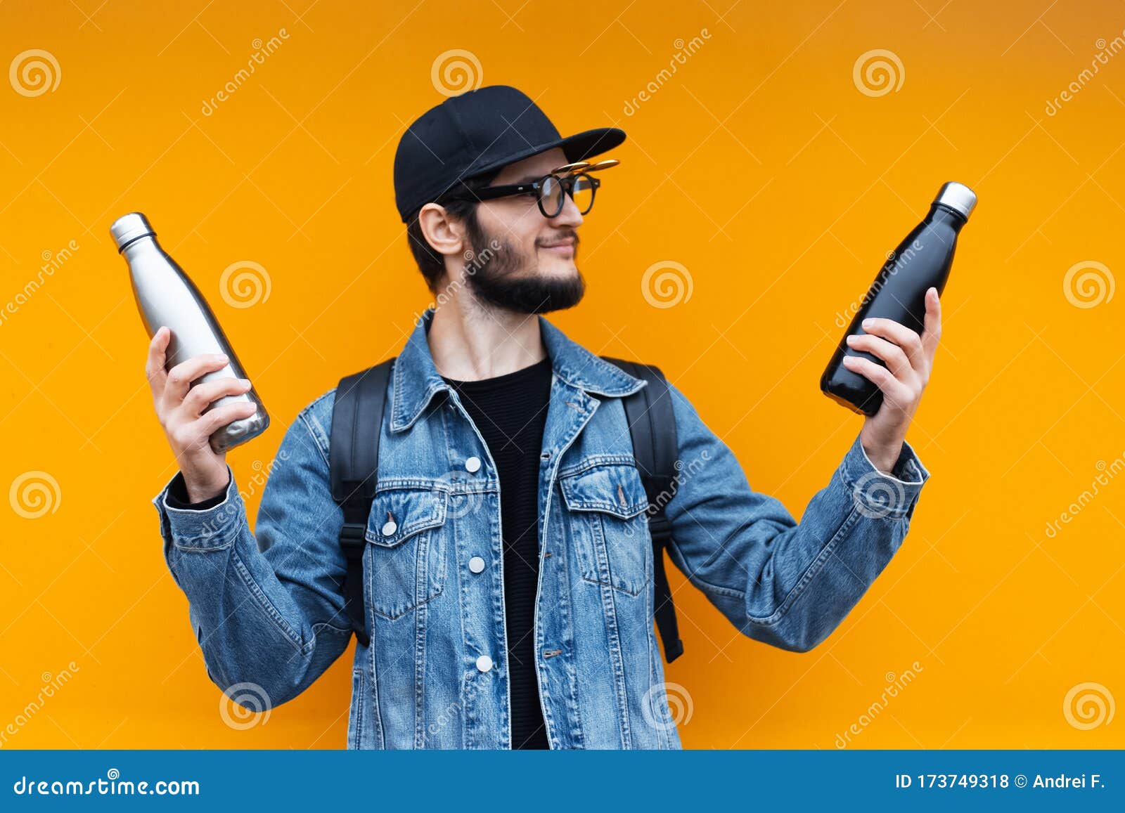 Portrait of Cheerful Young Hipster, Holding Black and Silver Stainless  Thermo Eco Bottle for Water, on Yellow Background. Stock Photo - Image of  cheerful, drink: 173749318