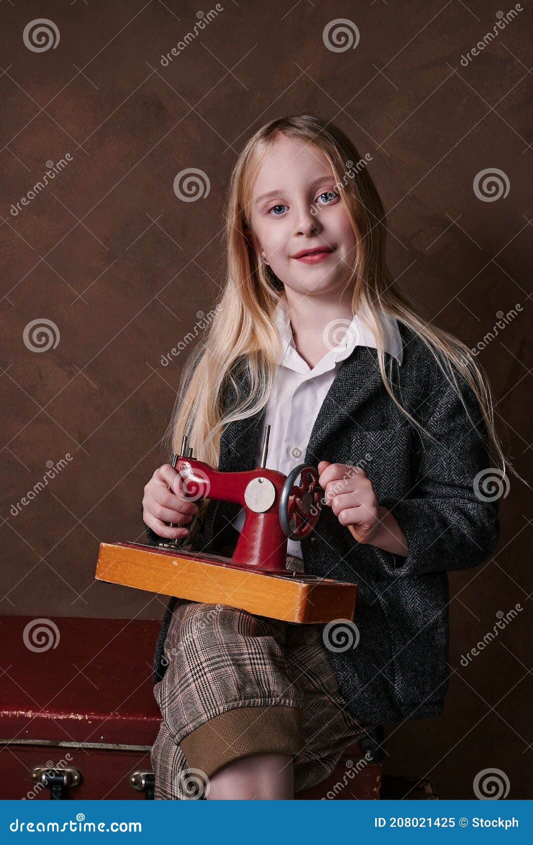 Portrait of Child with Small Sewing Machine. Retro Style Stock Image