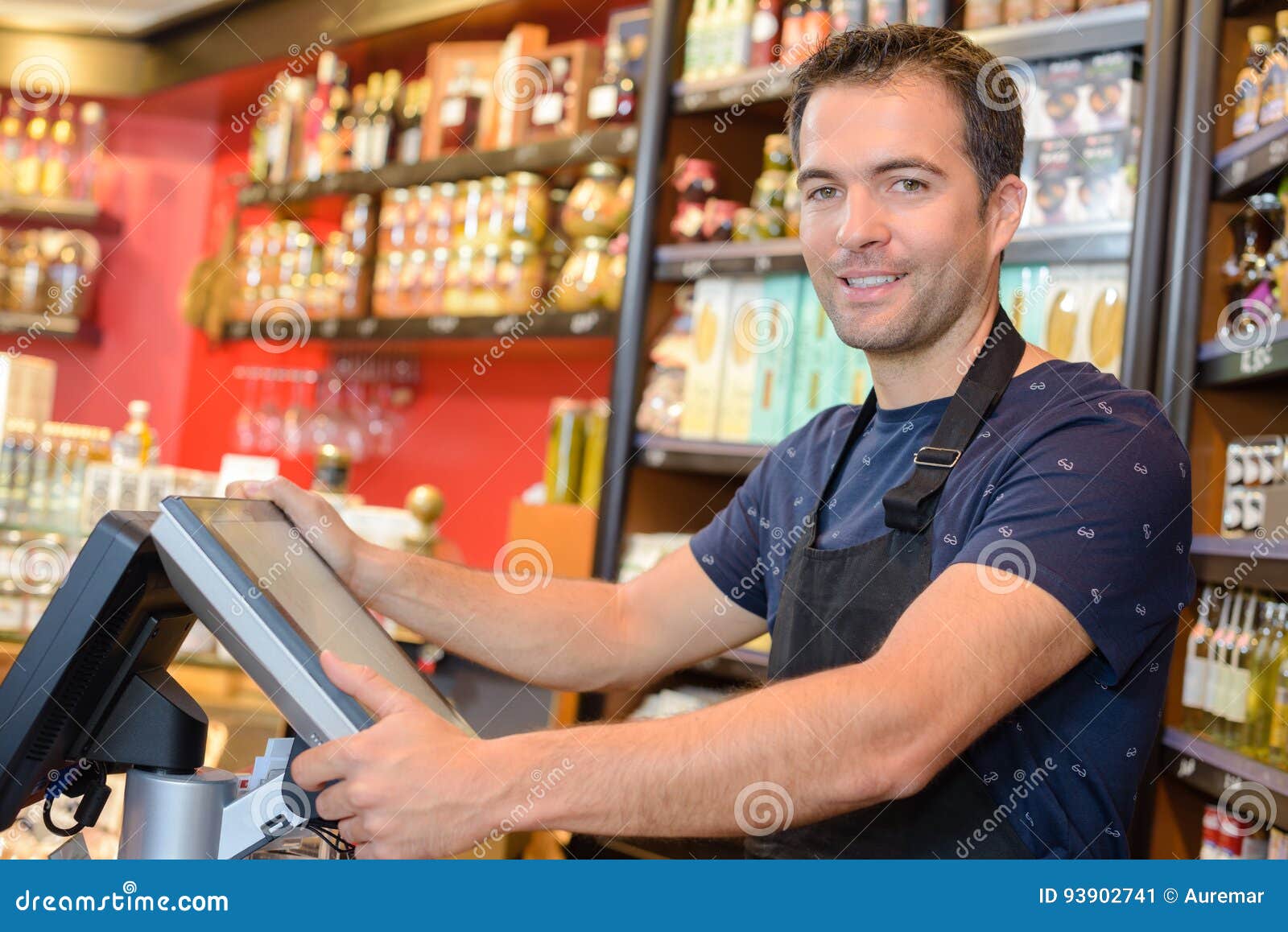 portrait clerk stood by electronic cash register