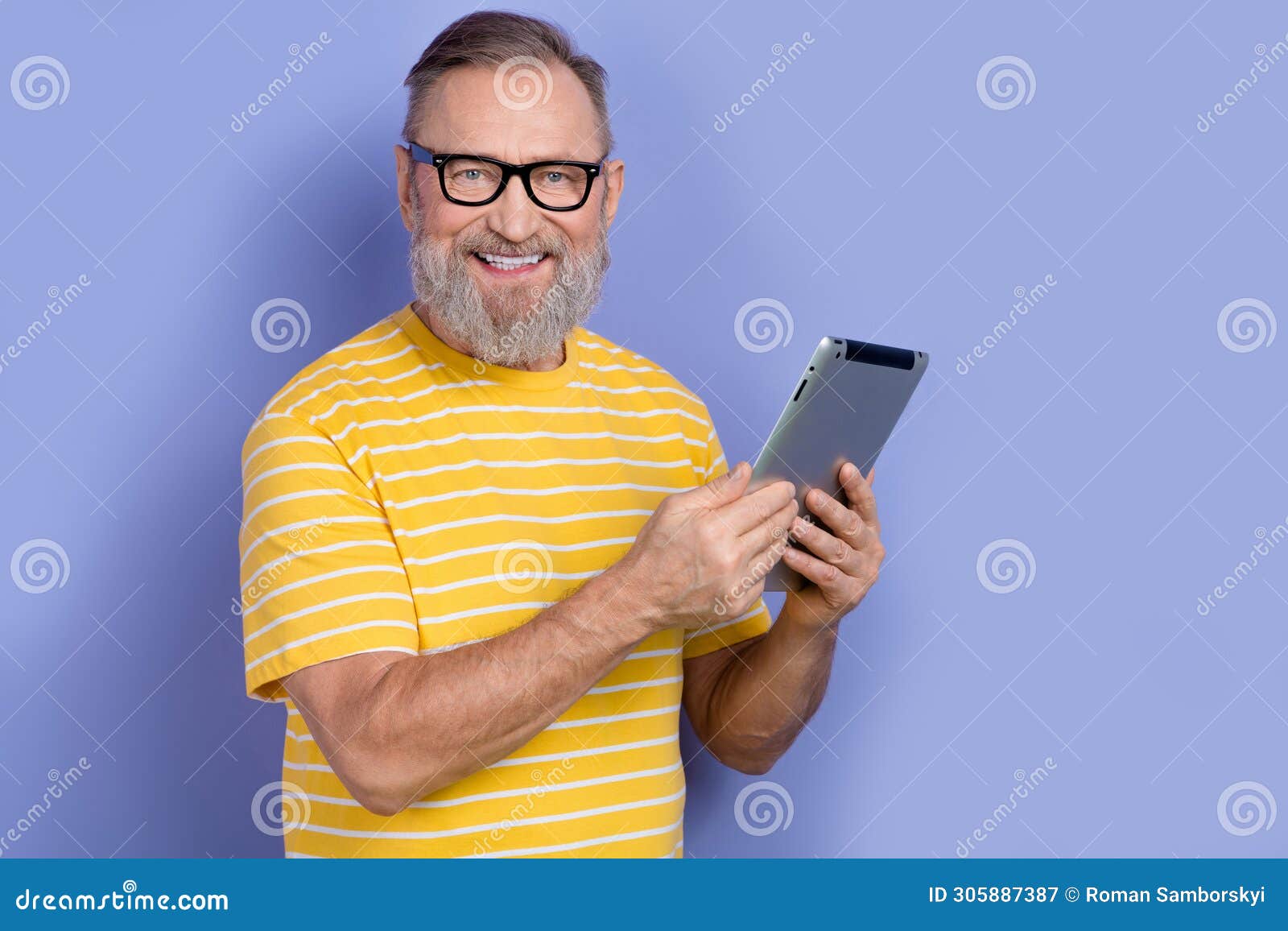 portrait of clever pensioner persone with beard wear yellow t-shirt in glasses hold tablet read email  on violet