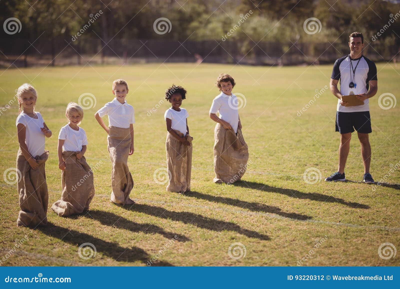 Portrait of Coach and Schoolgirls Standing in Park during Sack Race ...