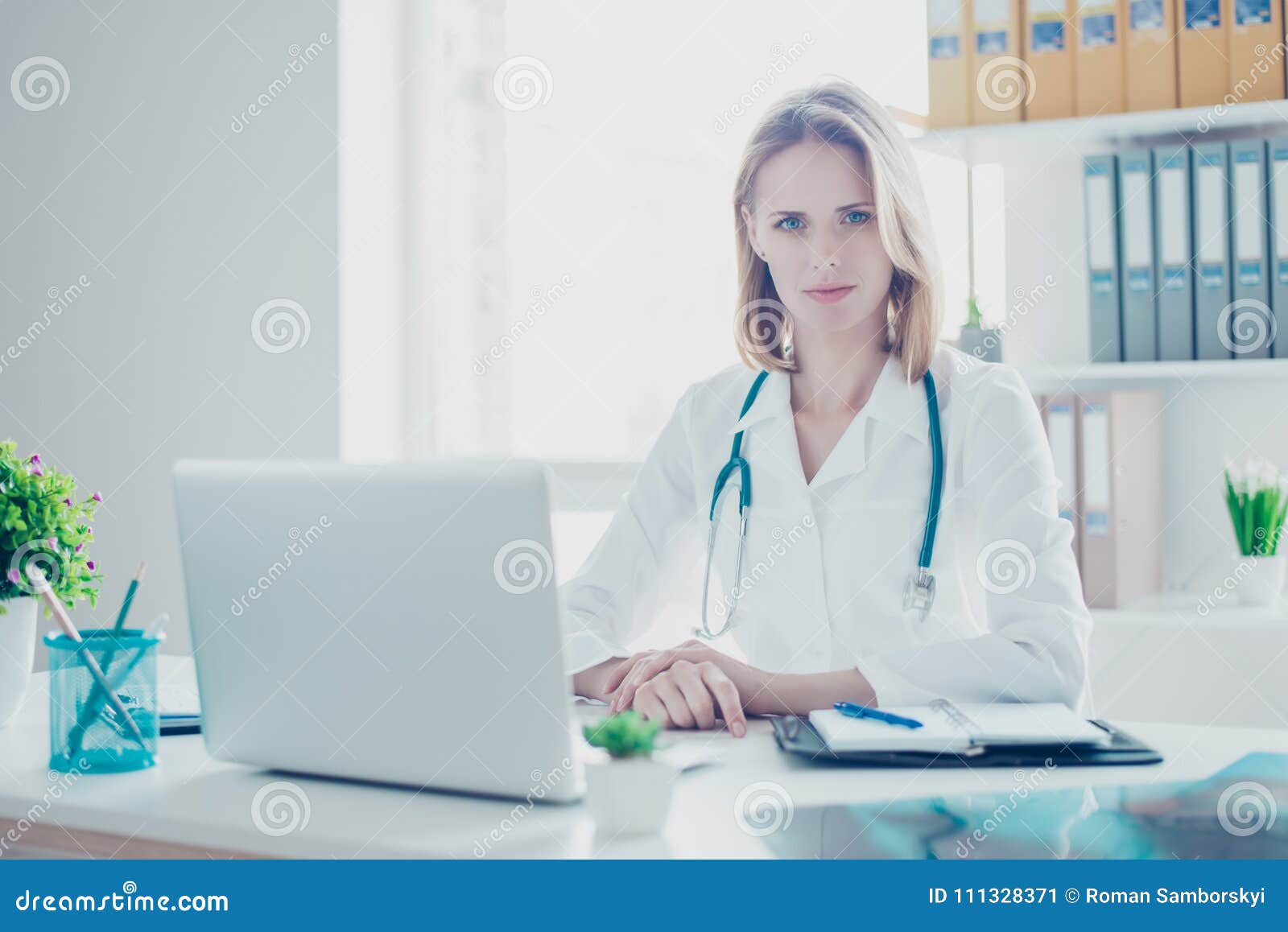 portrait of confident concentrated medico wearing white coat, sh