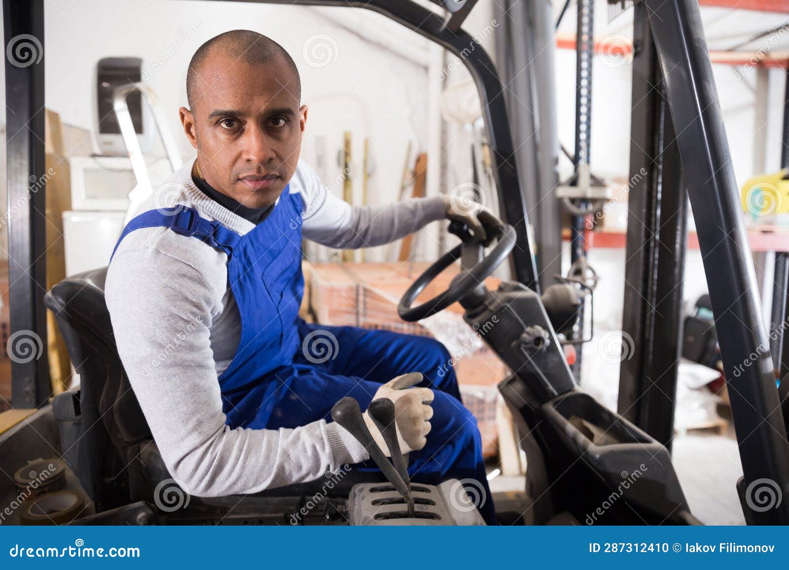 Confident Hispanic Worker Driving Forklift in Building Materials Store