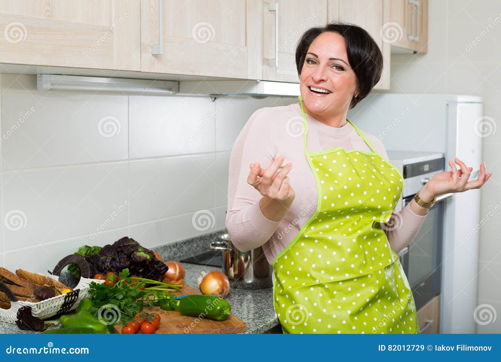 Portrait Of Cooking Brunette Housewife In Apron Stock I