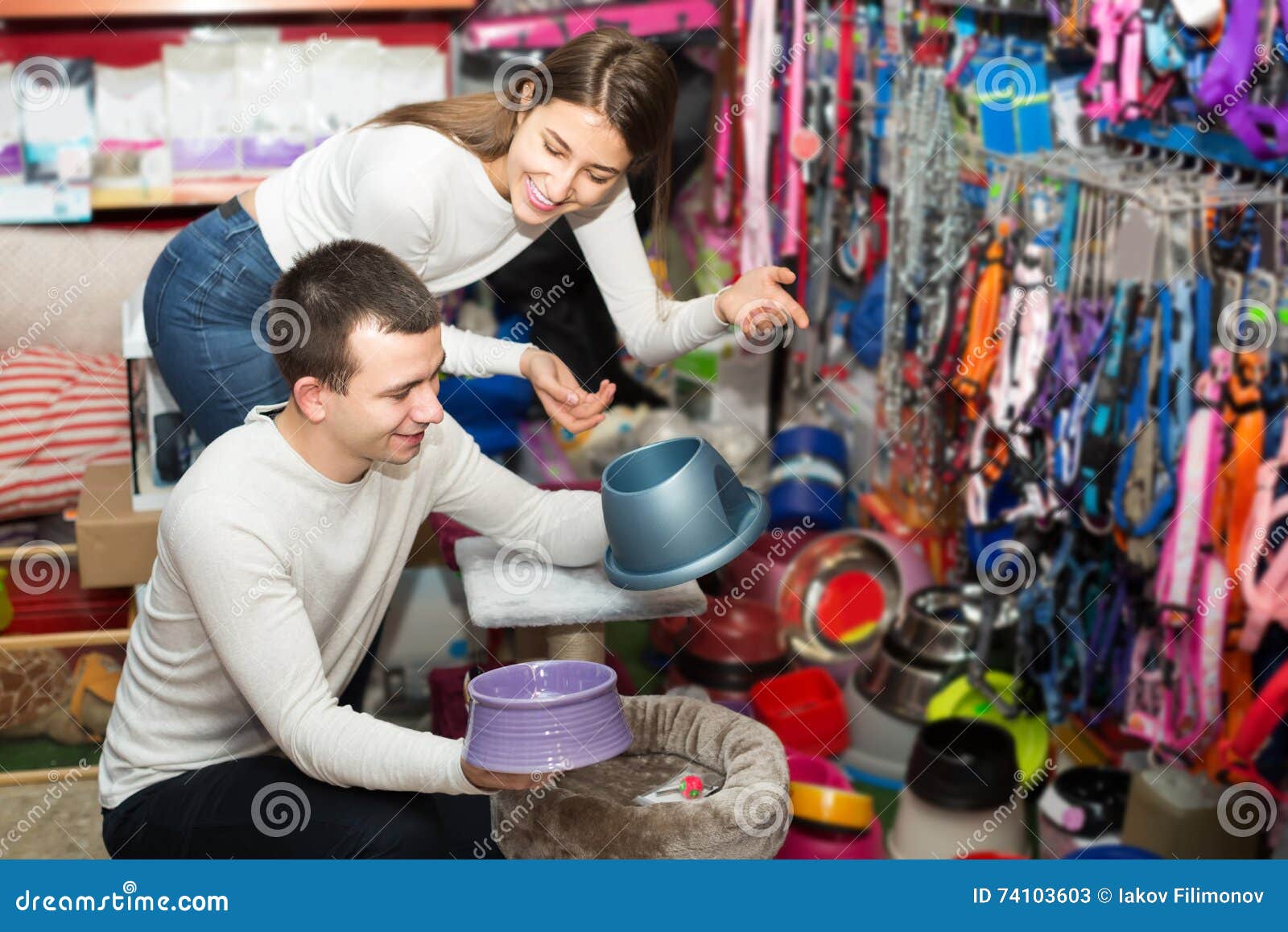 portrait of couple purchasing pet bowls in petshop