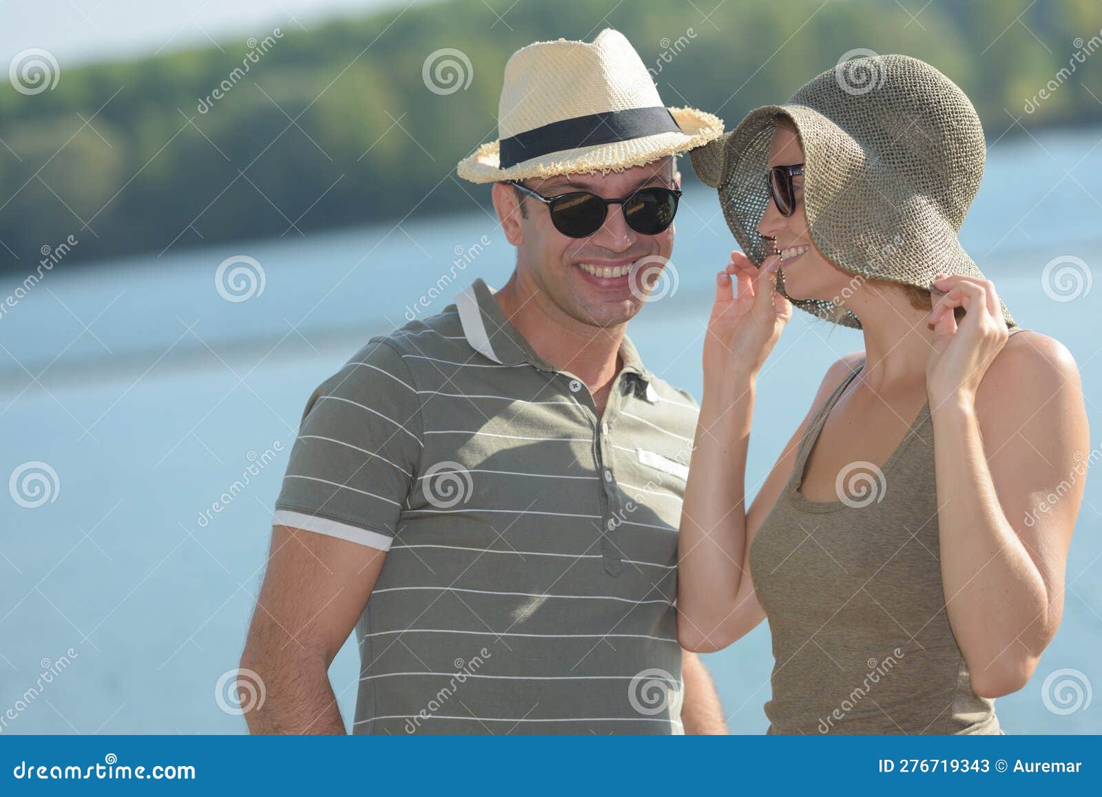 portrait couple wearing sunhats in sumemr weather