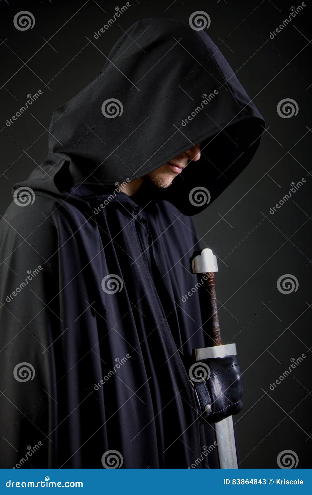 portrait of a courageous warrior wanderer in a black cloak and sword in hand.