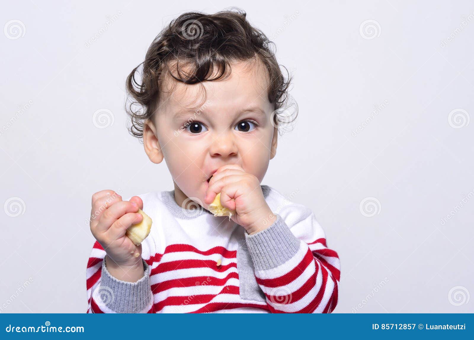 Portrait of a Cute Baby Eating a Banana. Stock Image - Image of grimace ...