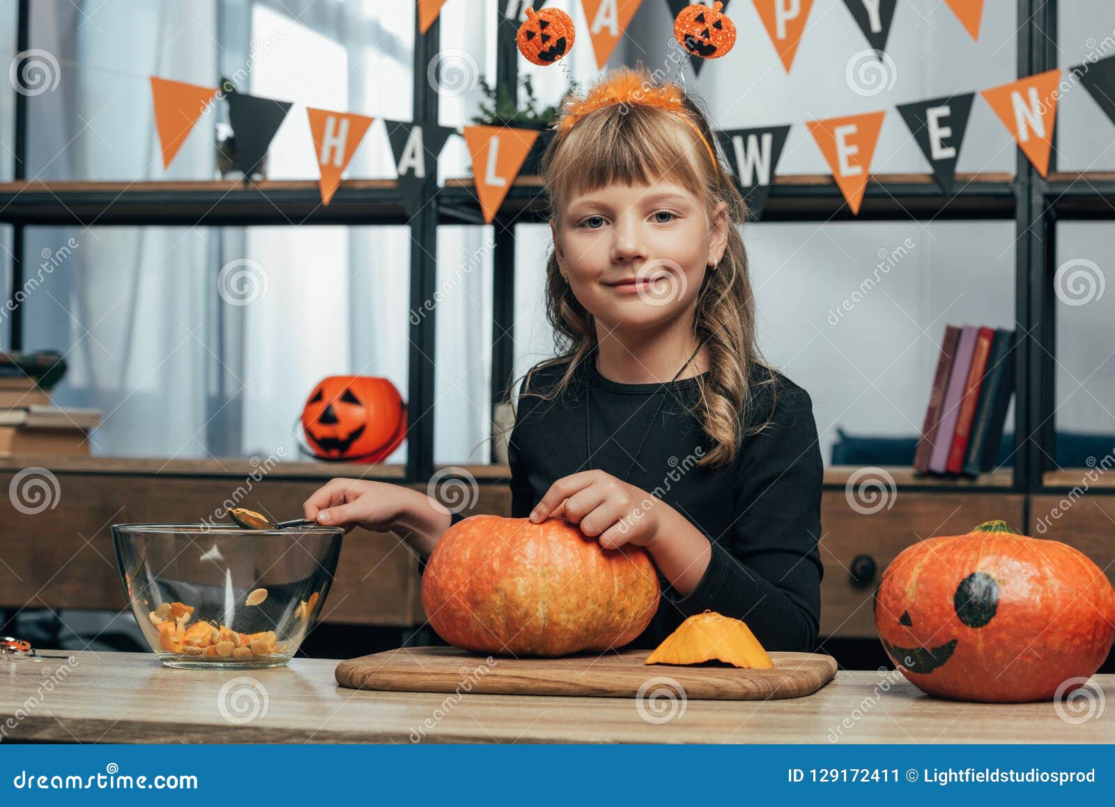 Portrait of Cute Kid Looking at Camera while Carving Pumpkin for ...