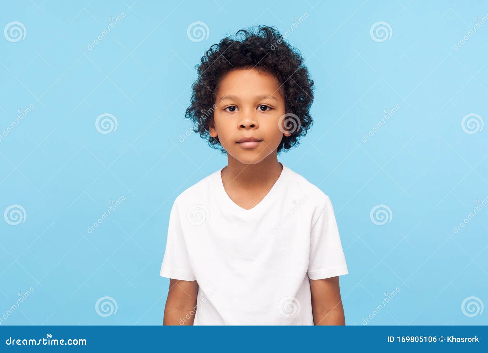 Portrait of Cute Little Boy with Stylish Curly Hairdo in White T-shirt Standing, Looking at Camera with Serious Attentive Face Stock Photo - Image of appearance, generation: 169805106 Portrait of Cute Little Boy with Stylish Curly Hairdo in White T-shirt Standing, Looking at Camera with Serious Attentive Face Stock Photo - Image of appearance, generation: 169805106