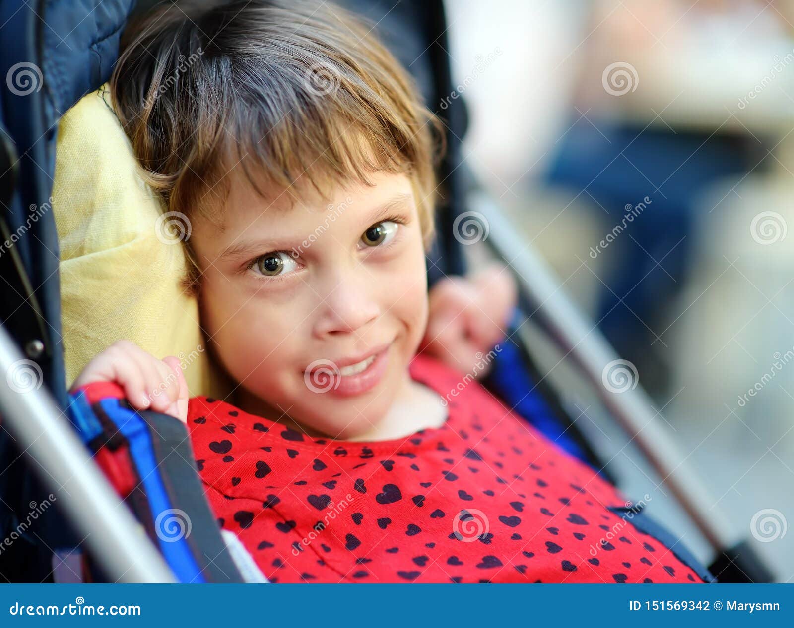 portrait of a cute little disabled girl in a wheelchair. child cerebral palsy. inclusion