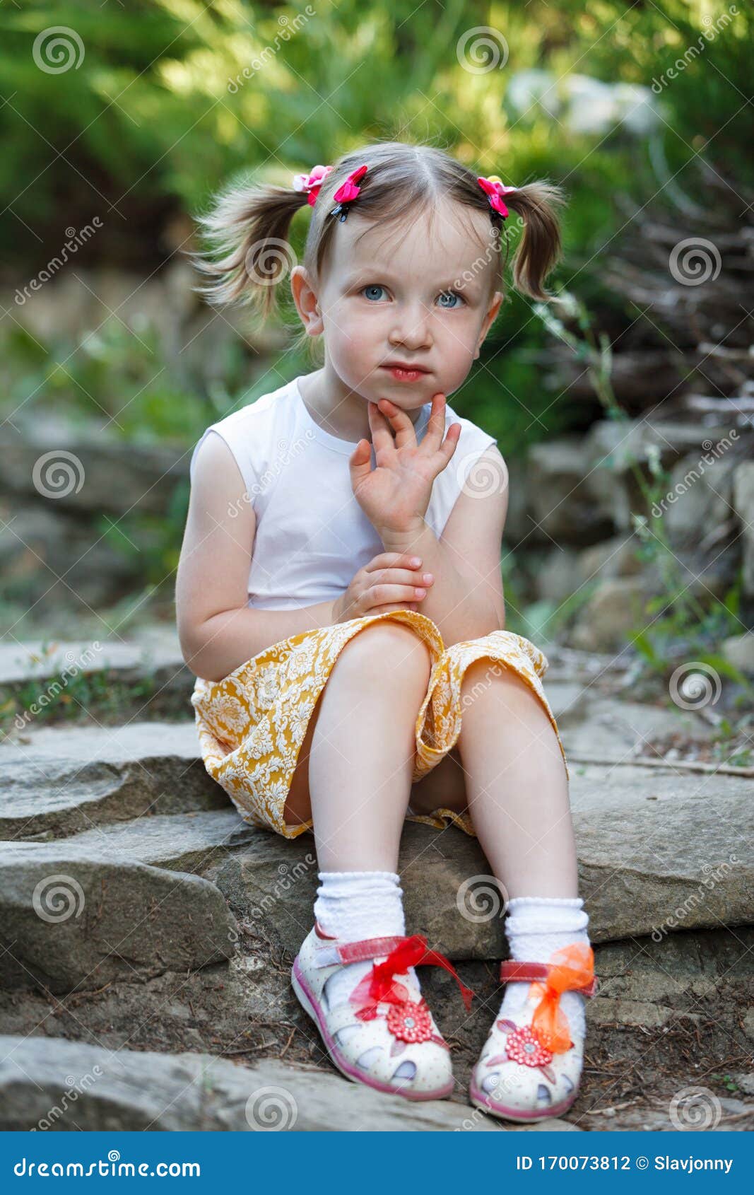 Portrait of a Cute Little Girl on the Background of Nature. she`s ...