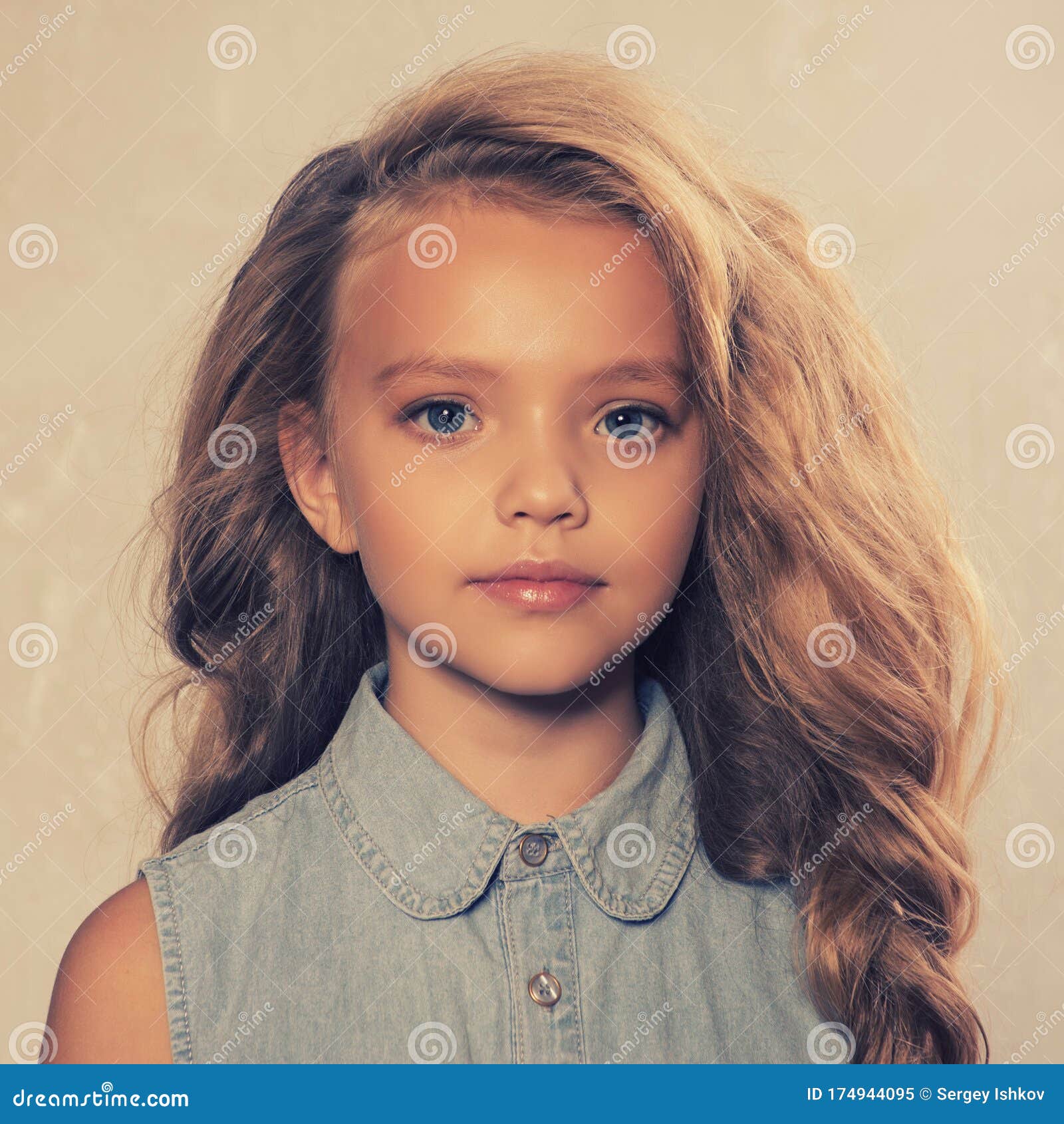 Portrait Of Cute Little 8-9 Year Old Girl With Blonde Hair, Wearing