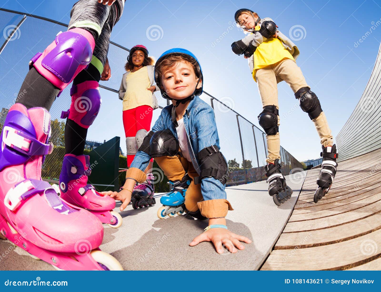 cute boy in roller skates having fun with friends