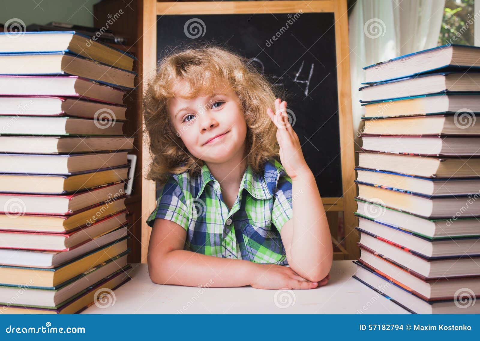 portrait of cute schoolgirl raising hand knowing the answer