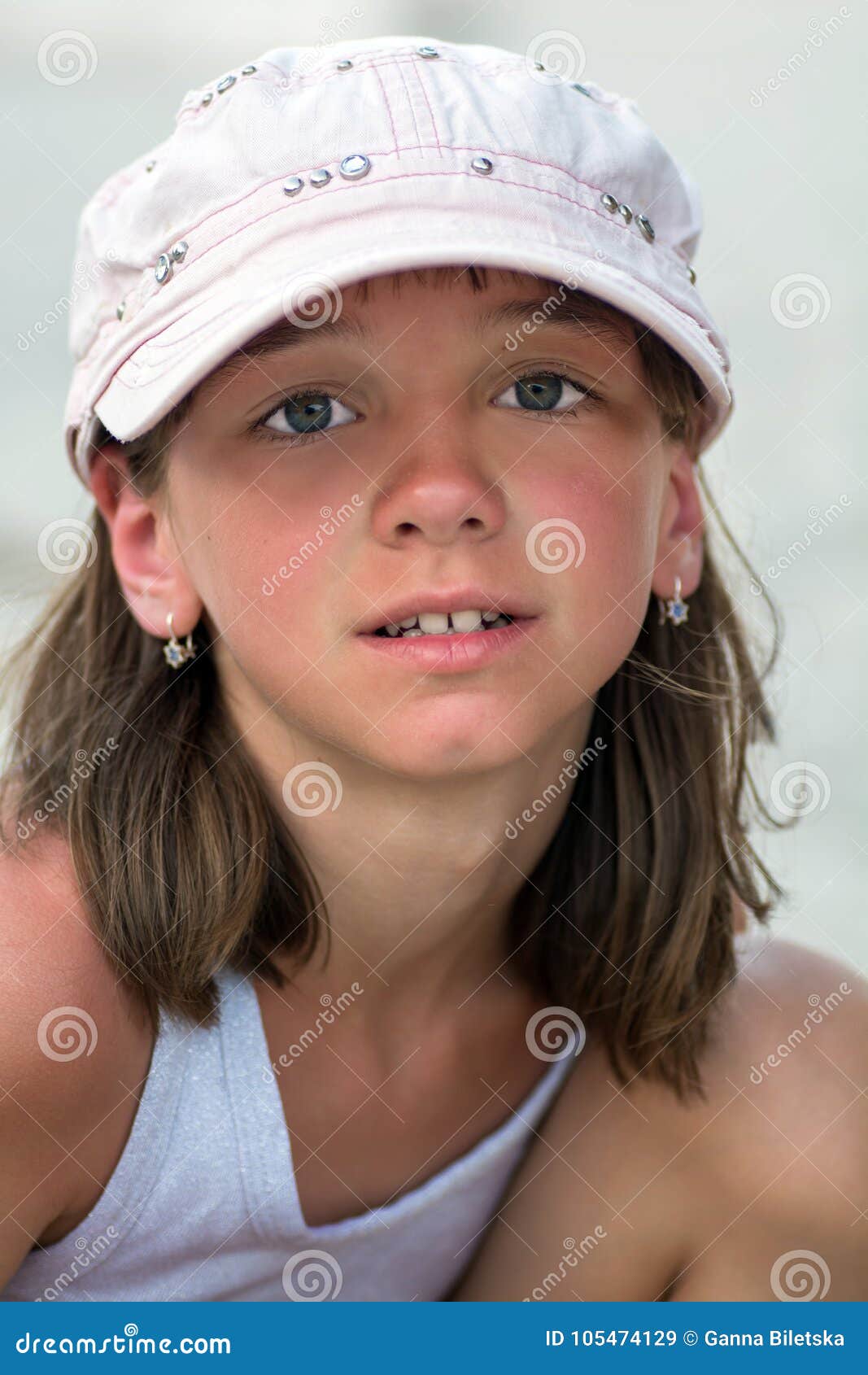 Portrait Of A Cute Tanned Girl With Big Beautiful Eyes In