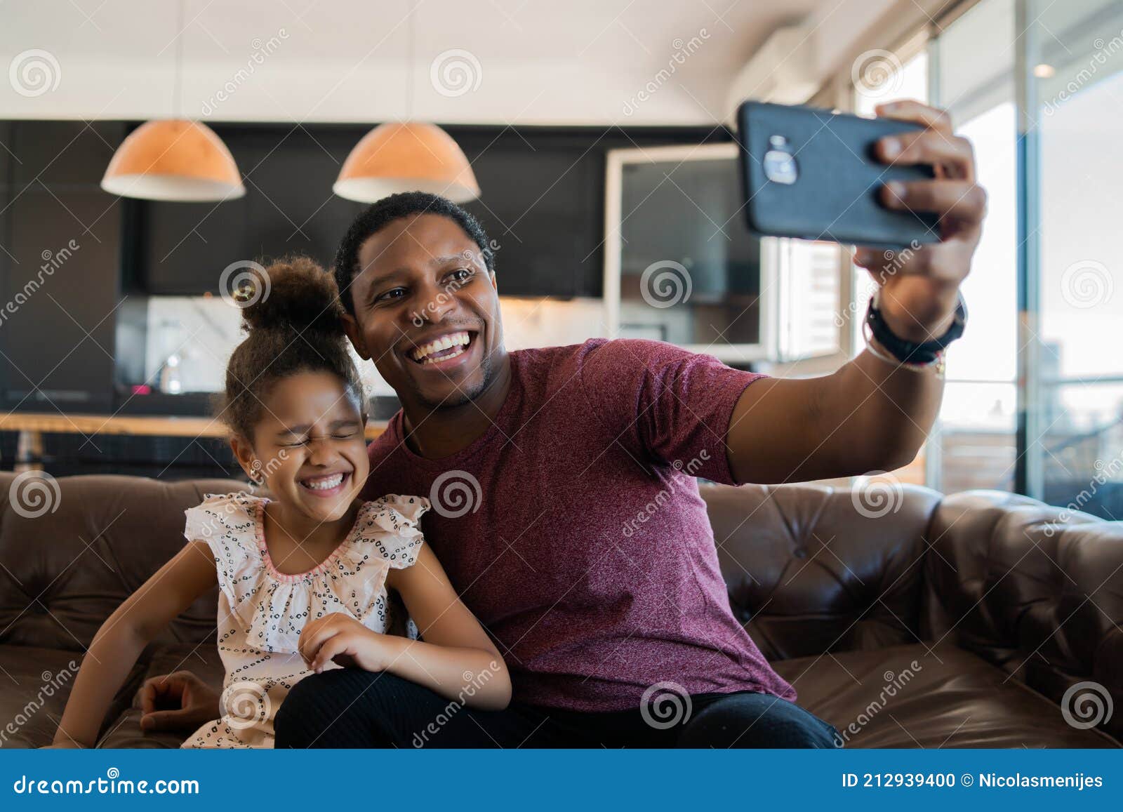 daughter and father taking a selfie with phone.
