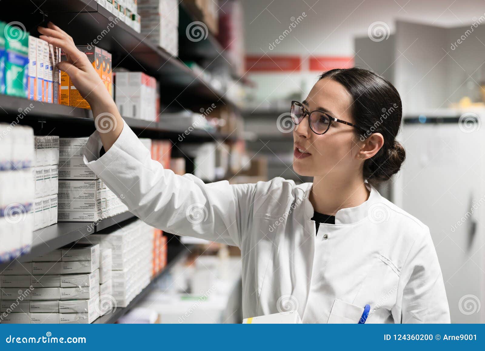 dedicated pharmacist taking a medicine from the shelf during work