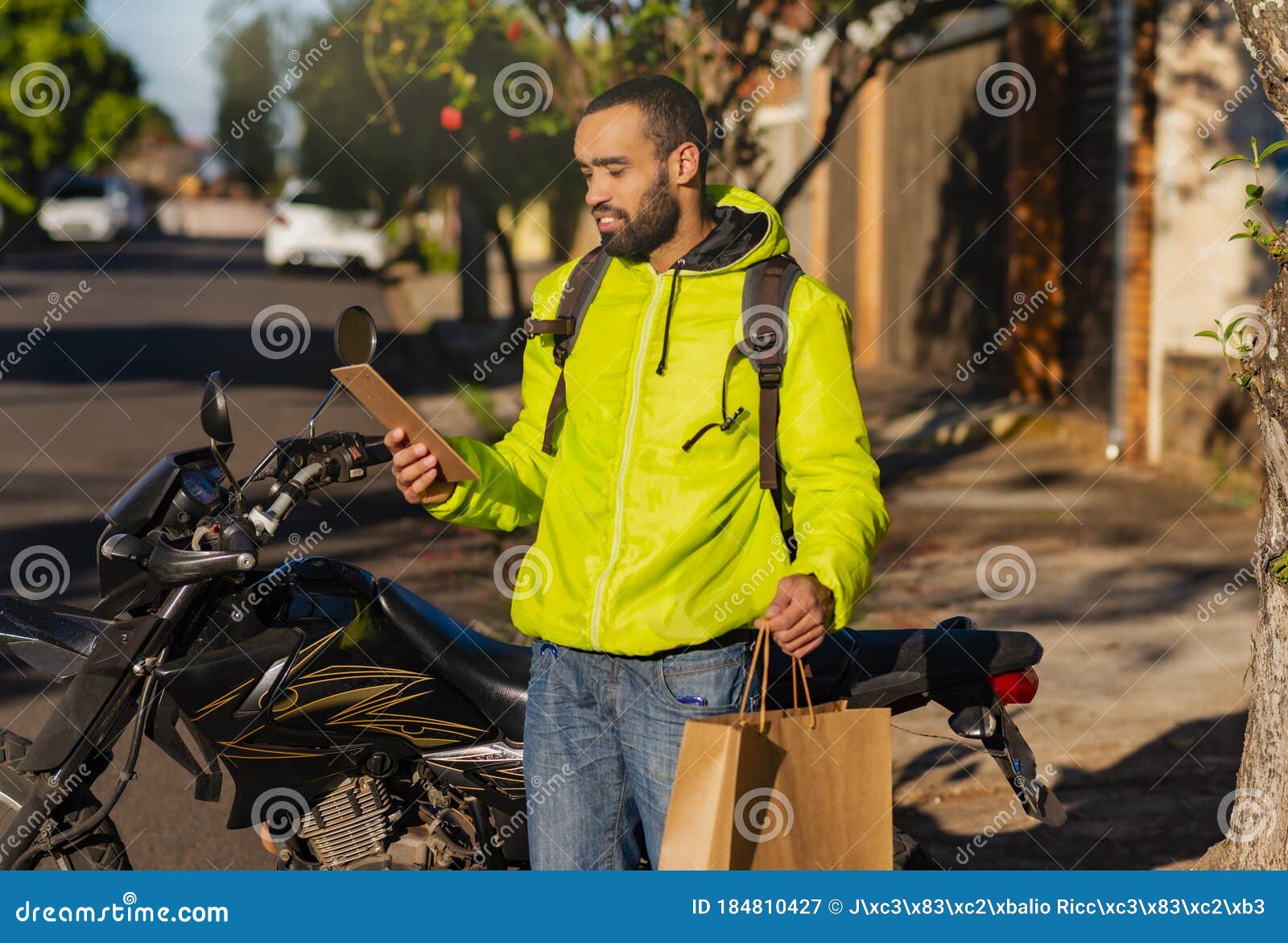 Portrait of Delivery Man with His Motorcycle with Delivery. Parcel
