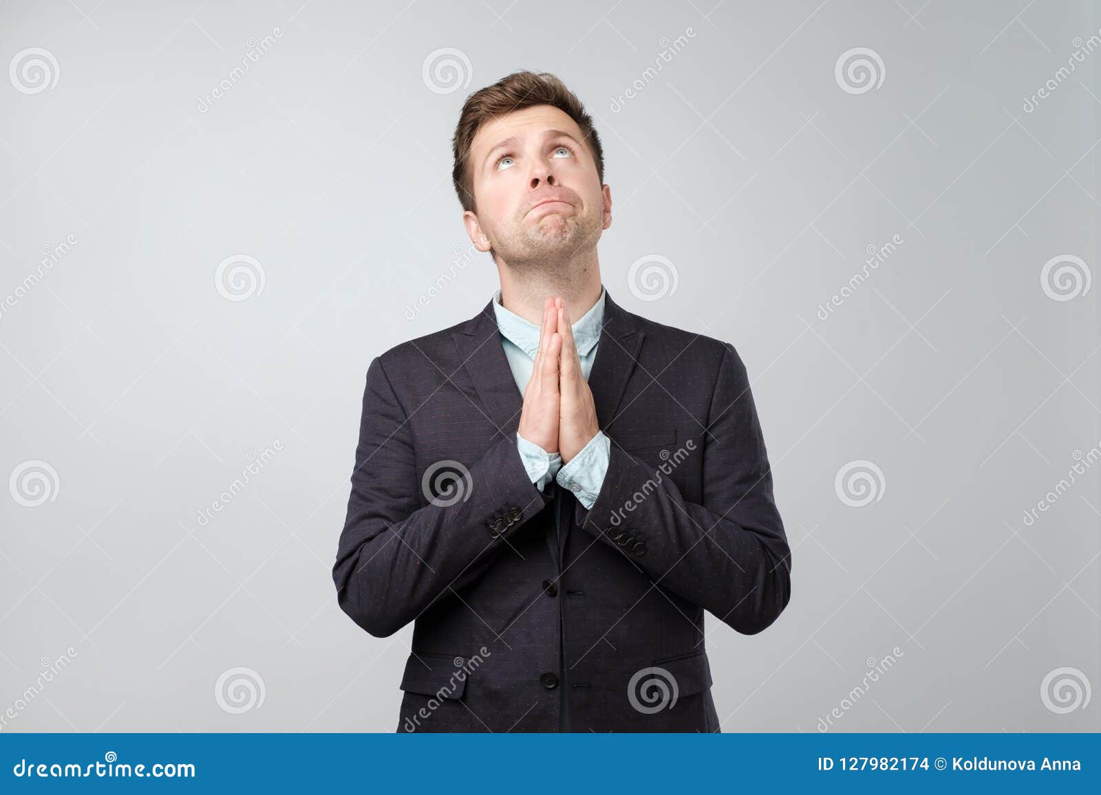 Portrait of Desperate Young Man Showing Clasped Hands, Asking for Help ...