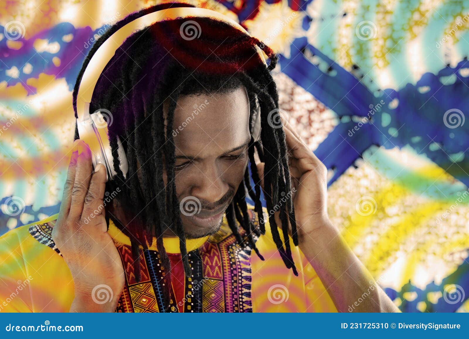 portrait of a disc jockey (dj) listening to reggae music, dreadlocks, audio headset, colored background, photo