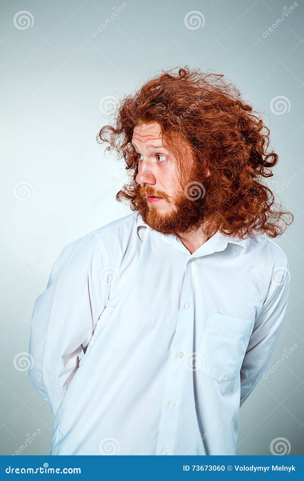 The portrait of disgusted man with long red hair