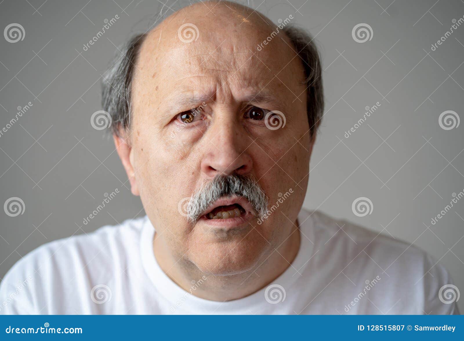 portrait of disorientated and confused old man suffering from alzheimer