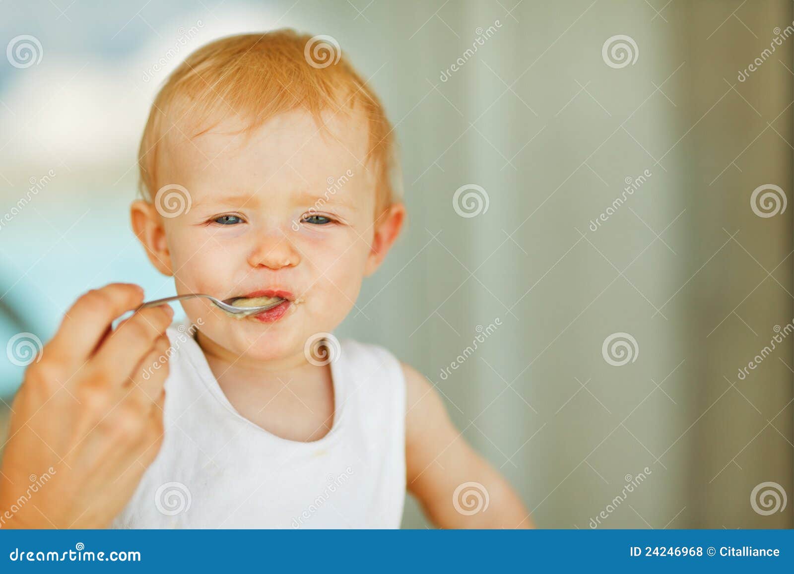 Portrait of eat smeared baby feeding by mom. Portrait of baby feeding by mother