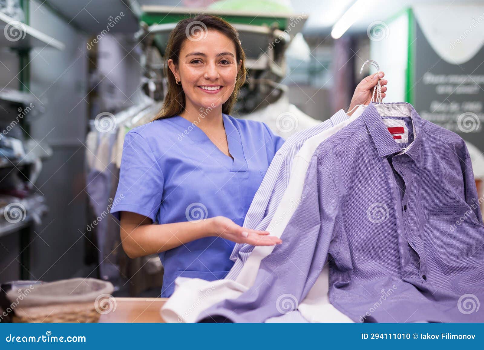 Portrait of Efficient Friendly Female Laundry Worker at Workplace Stock