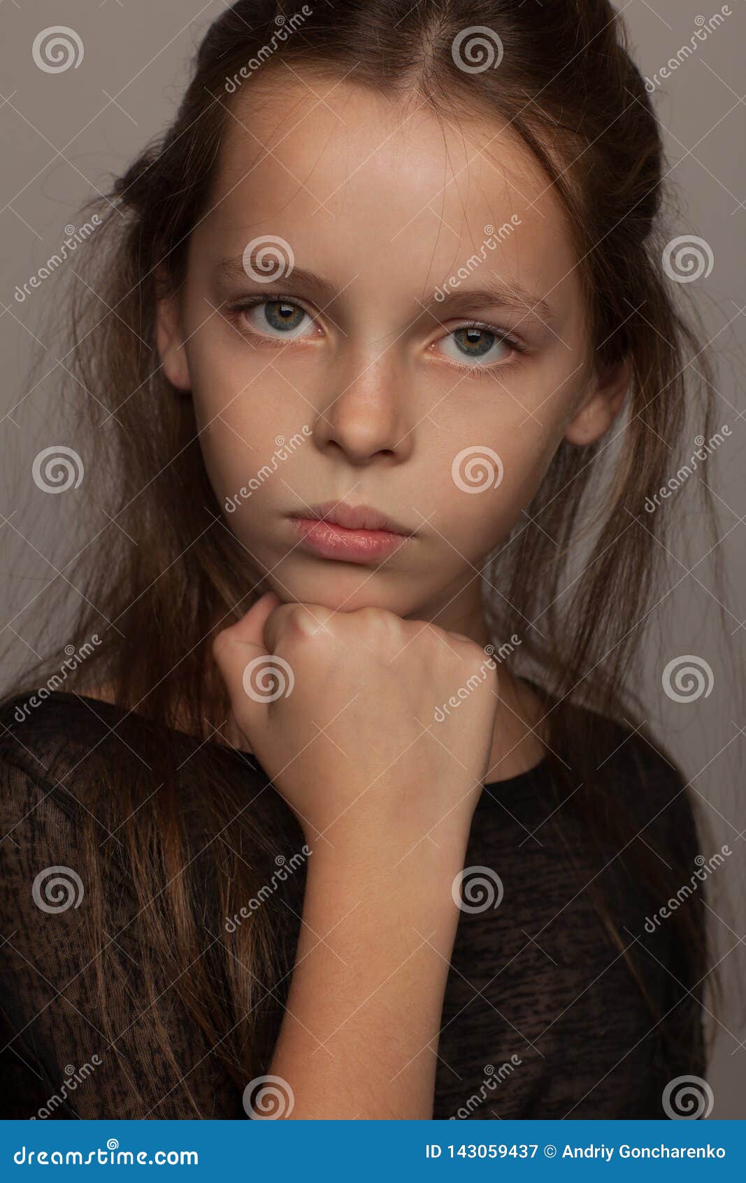Portrait Of An Eight-Year-Old Girl With A Calm Mood, In A Black Blouse And With Picked Up Hair Stock Photo 143059437 - Megapixl Portrait Of An Eight-Year-Old Girl With A Calm Mood, In A Black Blouse And With Picked Up Hair Stock Photo 143059437 - Megapixl