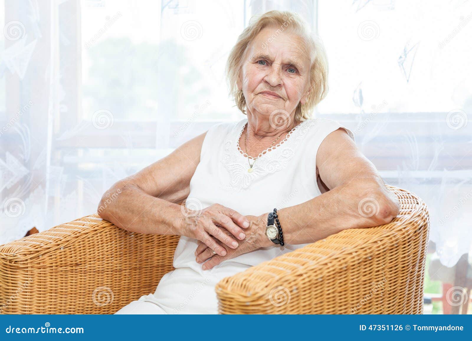 Portrait Of An Elderly Lady Sitting In A Chair Stock Photo Image