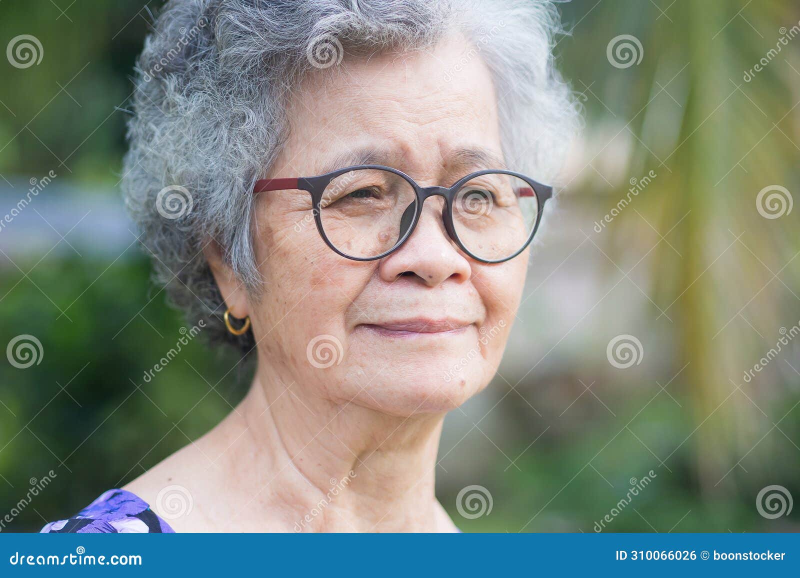 Portrait of an Elderly Woman with Short Gray Hair Looking Away while