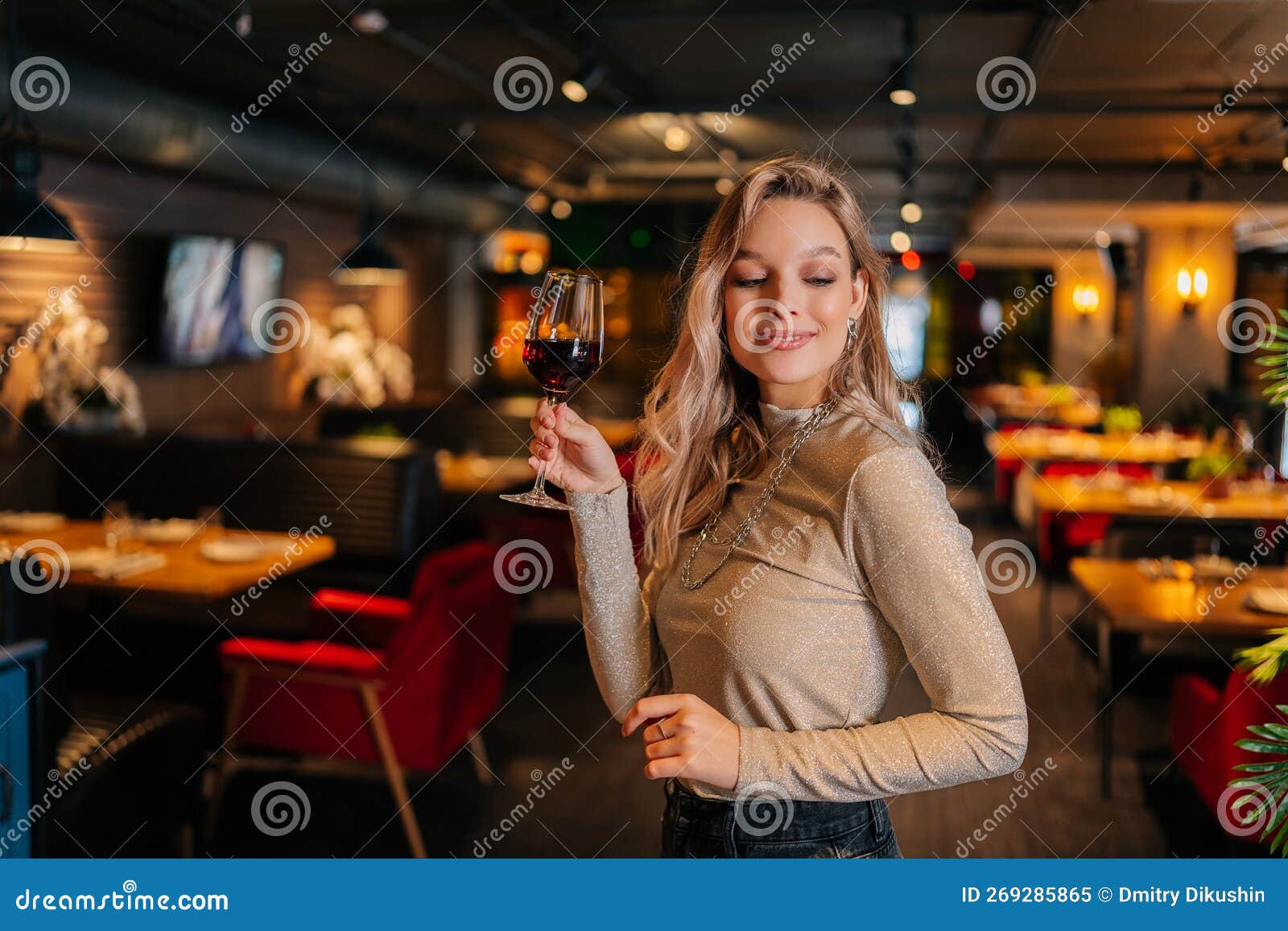 Portrait of Elegant Blonde Woman Holding Glasses of Red Wine Standing ...