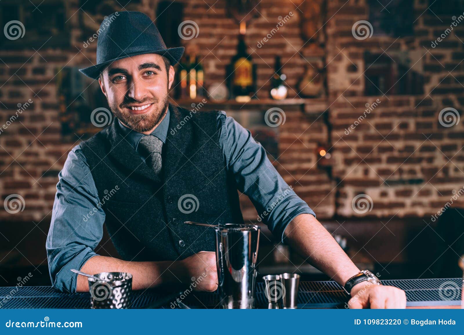 Portrait of Elegant and Stylish Bartender Wearing Hat and Vintage Clothes  while Preparing Drinks and Cocktails Stock Photo - Image of distilled,  drink: 109823220