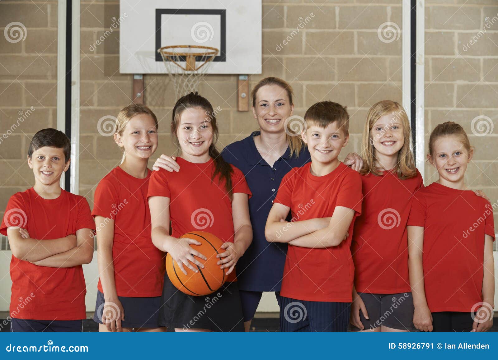 Portrait of Elementary School Basketball Team with Coach Stock Image