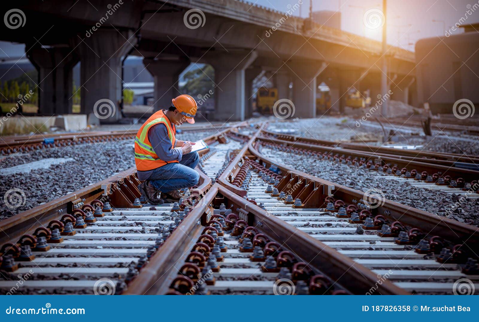 portrait engineer under inspection and checking construction process railway switch and checking work on railroad station .enginee