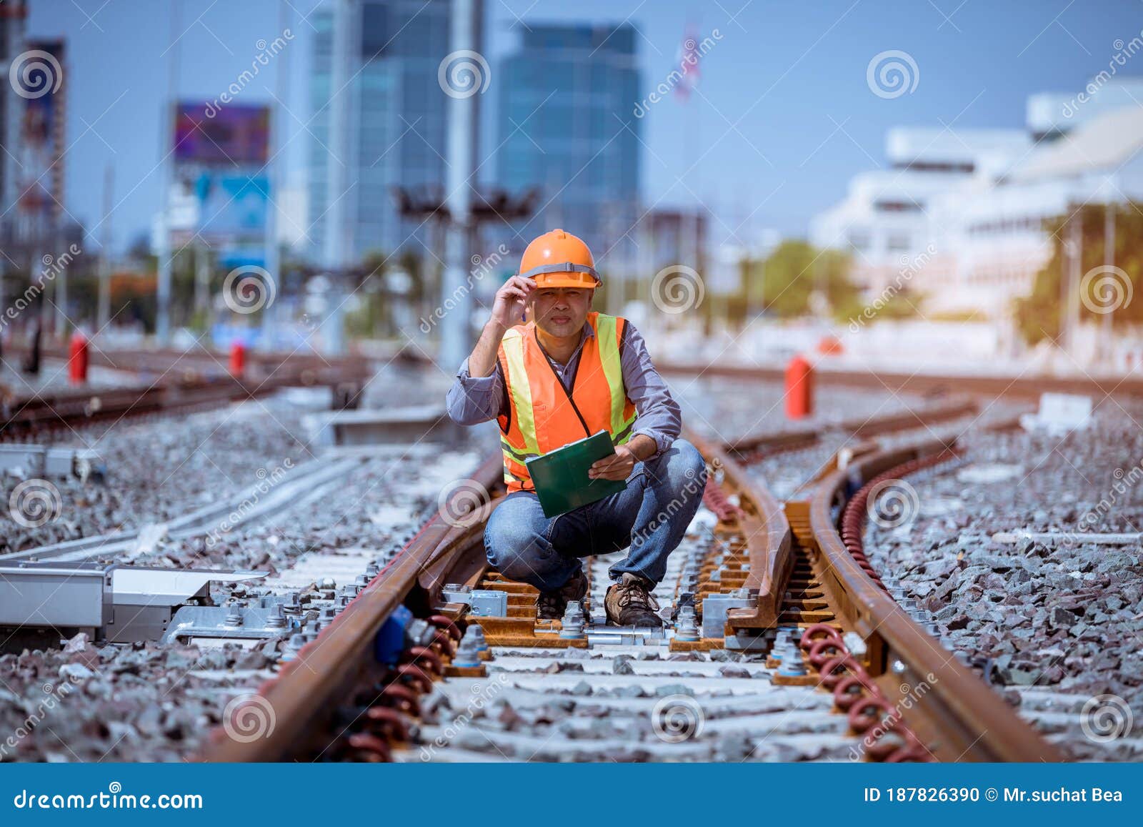 portrait engineer under inspection and checking construction process railway switch and checking work on railroad station .enginee