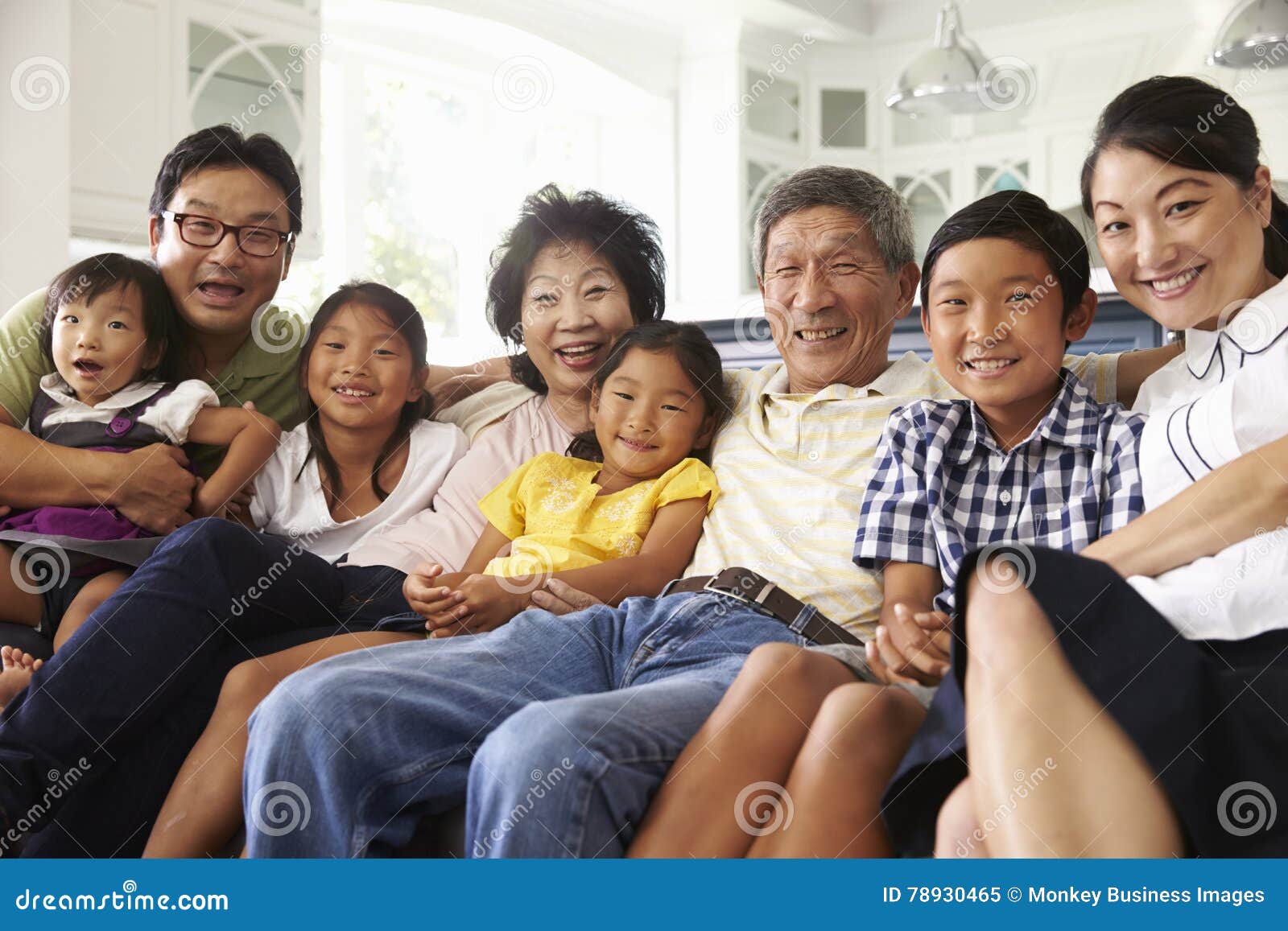 Portrait of Extended Family Group Sitting at Home on Sofa Stock Image