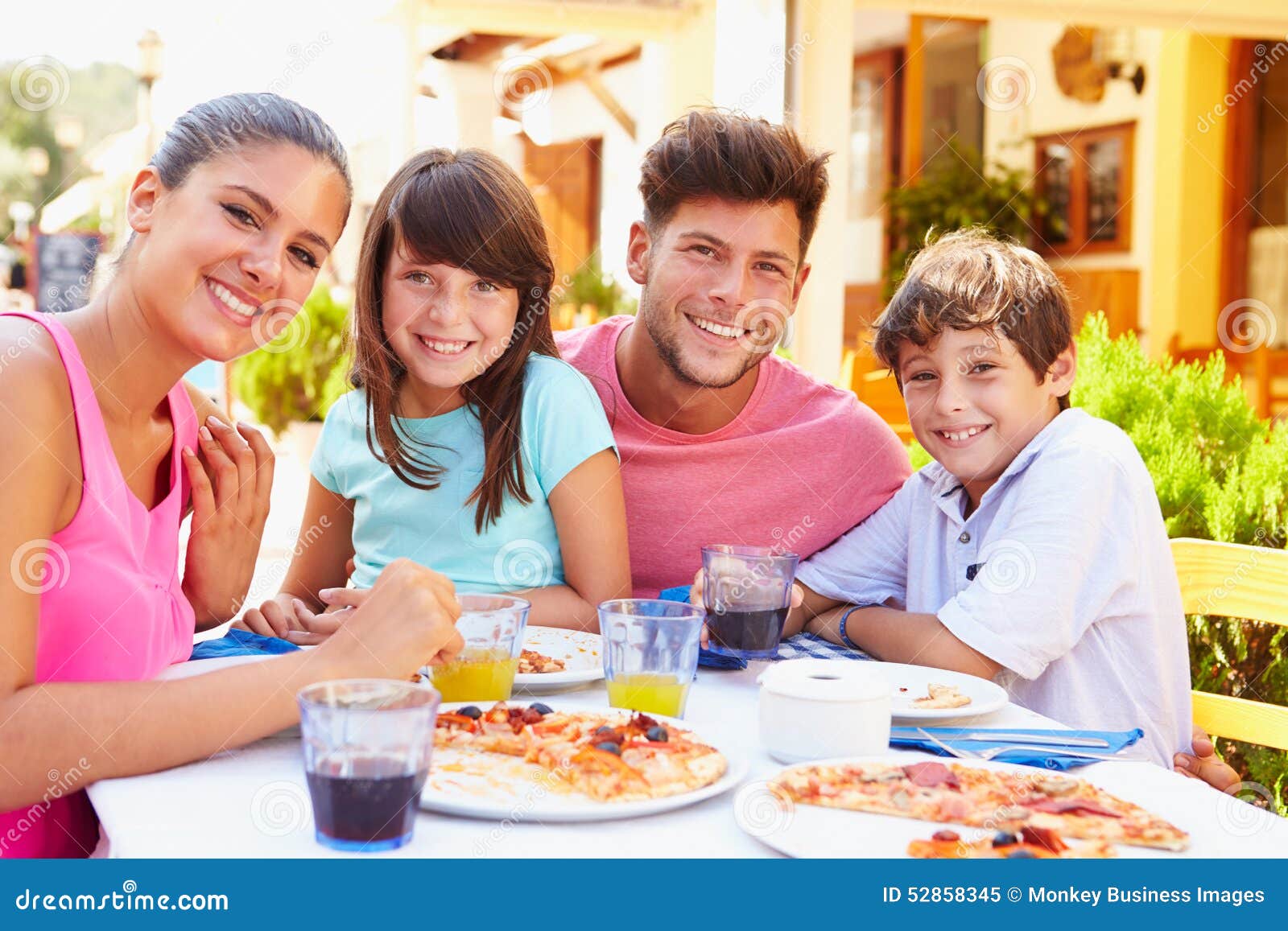 Portrait of Family Eating Meal at Outdoor Restaurant Stock Image