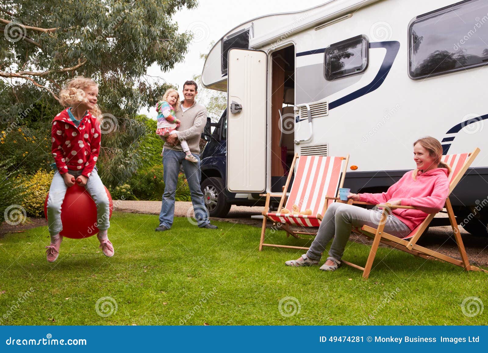 portrait of family enjoying camping holiday in camper van