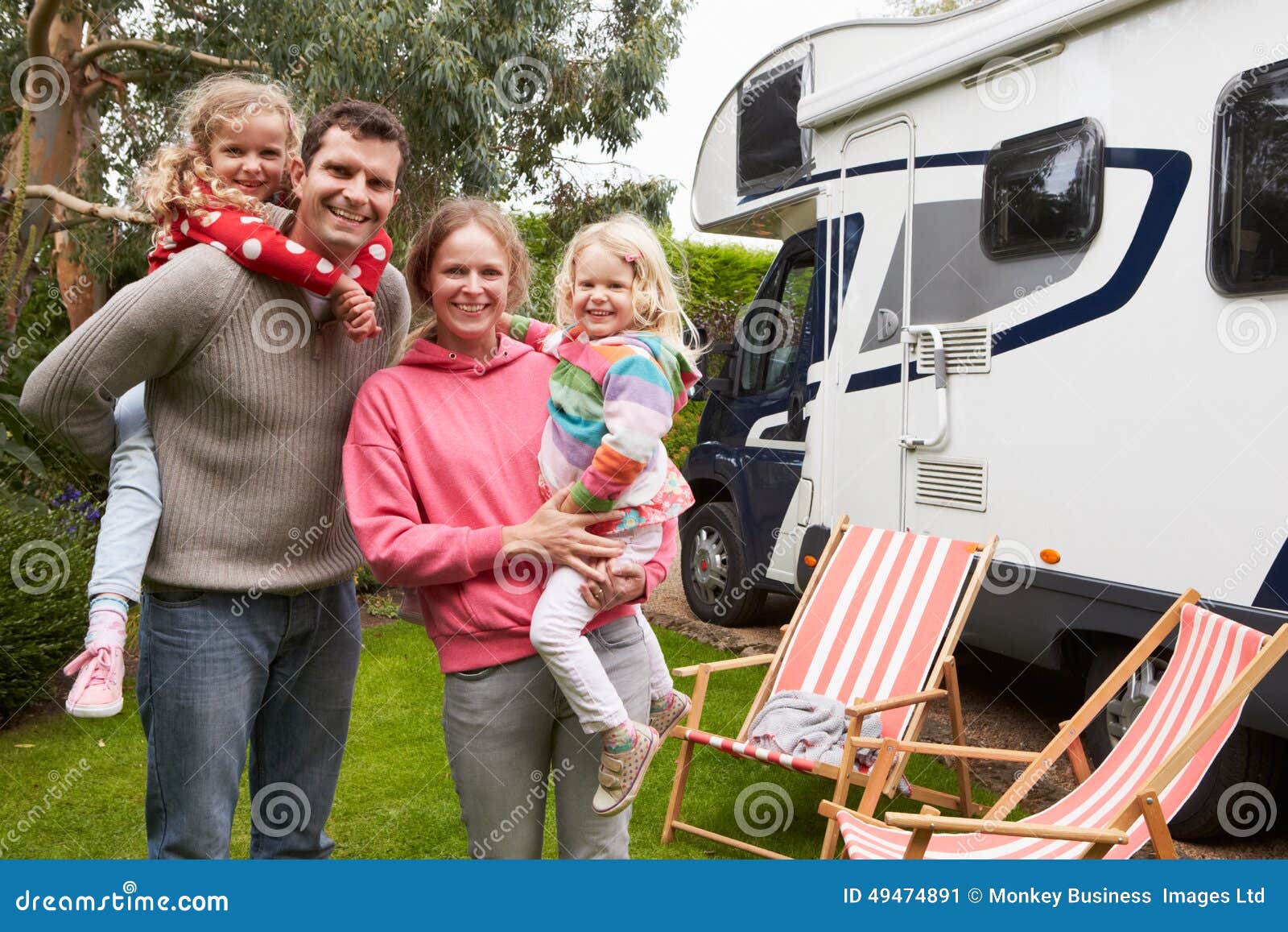 portrait of family enjoying camping holiday in camper van